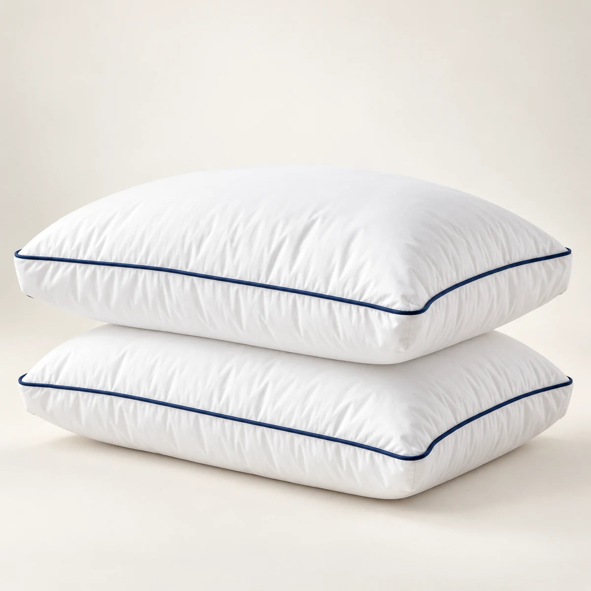 Two white Cool Budget gel-feel gusseted pillows with navy piping
