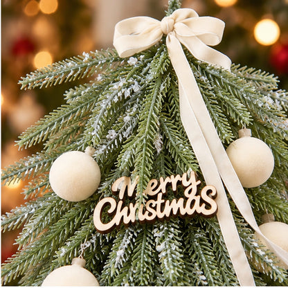 Nordic Tabletop Decorated Mini Christmas Tree with Wood Log Base – wooden Merry Christmas sign and ribbon bow closeup