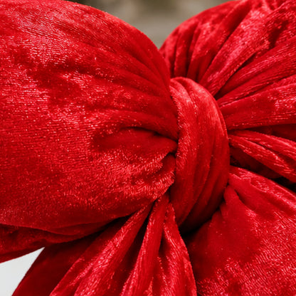 Red Velvet Puffy Christmas Bow Tree Topper & Holiday Decoration – plush velvet knot and fabric texture closeup